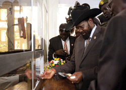 South Sudan’s president Salva Kiir receives new South Sudan pounds in 2011 at the Central Bank of South Sudan in Juba