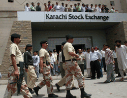 Shareholder backlash: paramilitary forces patrol during a protest at the Karachi Stock Exchange on July 17. Hundreds of angry investors, upset by plunging share prices, demanded a temporary closure of the market