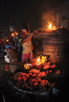 Lagos market traders selling by kerosene lantern light: low electricity-generation capacity is hampering Nigeria’s economic development