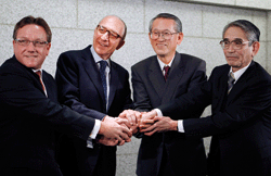 Morgan Stanley Japan Securities president Jonathan Kindred, Morgan Stanley co-president Walid Chammah, MUFG president and CEO Nobuo Kuroyanagi and Mitsubishi UFJ Financial Securities president Fumiyuki Akikusa shake hands in Tokyo on March 26
