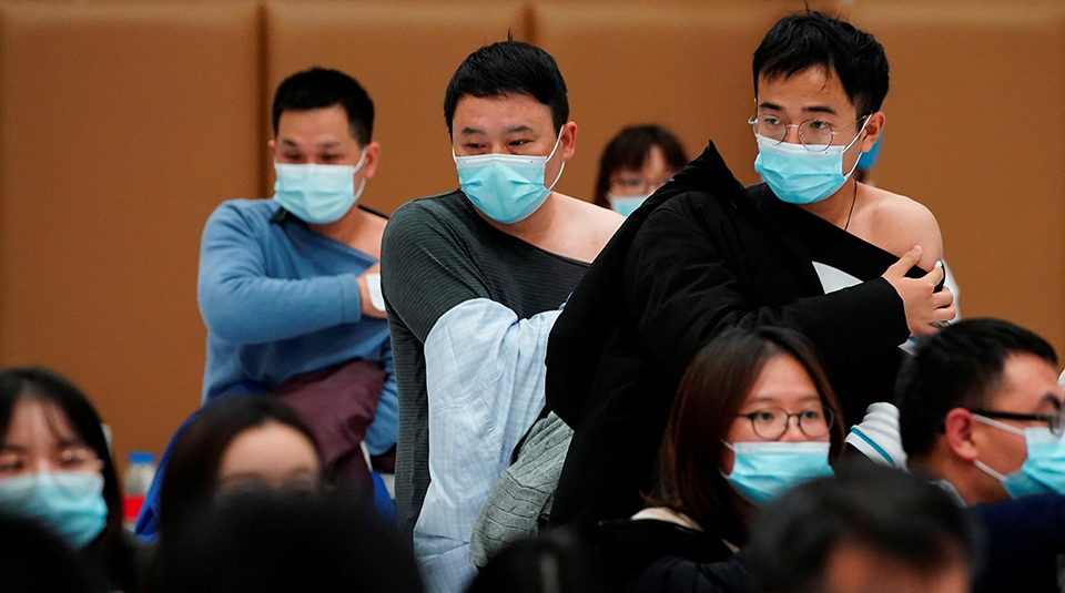 People stand at a vaccination site after receiving a dose of a coronavirus disease (COVID-19) vaccine, in Shanghai