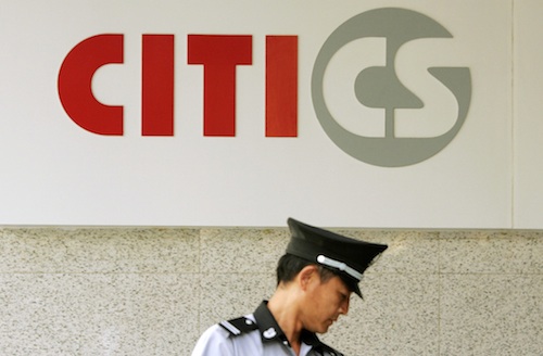A security guard is seen under the logo of CITIC Securities at a branch of the security brokerage house in Shanghai