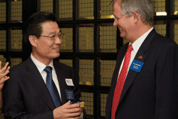 Chen Wenjun of the State Council Information Office and Jacko Maree, CEO of Standard Bank, exchange gifts in Johannesburg